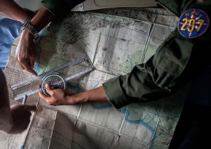 Indonesian Army personnel read a map during a search and rescue (SAR)